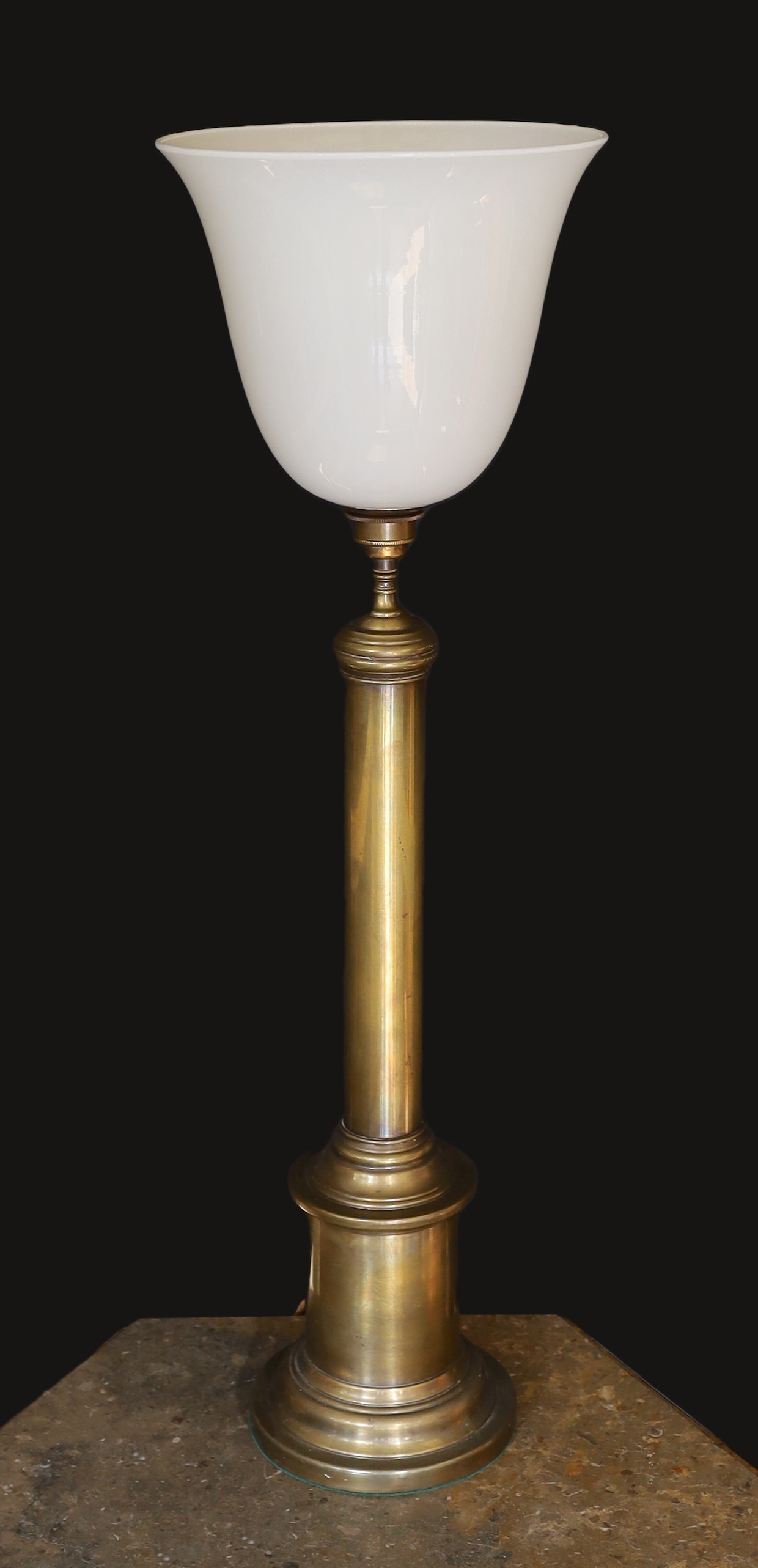 A 1950’s oxidised brass column table lamp with opaque white glass uplighter shade, height overall 84cm